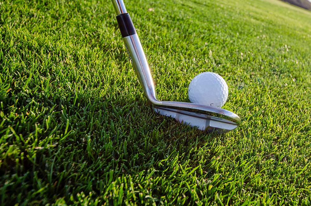 Hitting from an uphill lie near the green can be tricky for gauging distance. Any tips for this shot?