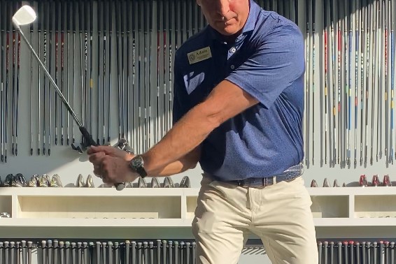 What should your wrists do in a golf swing?